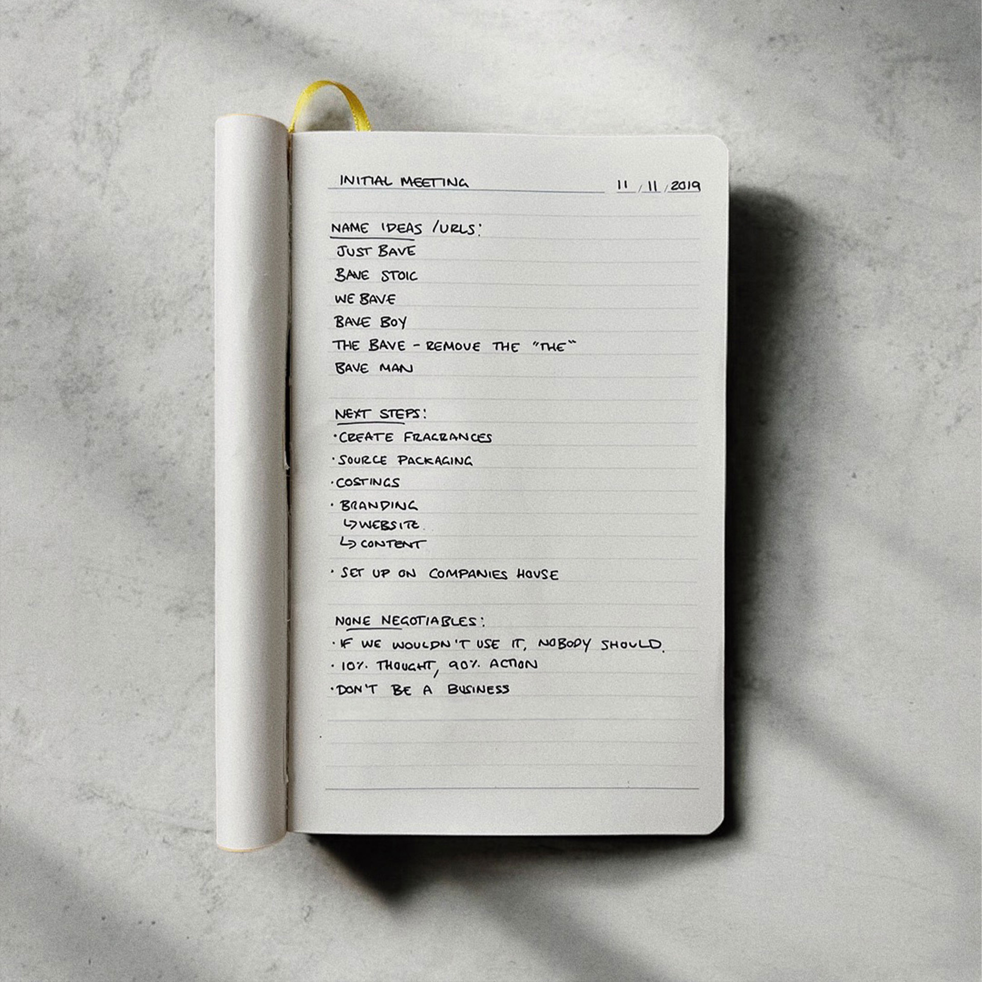 BAVE brand strategy notes in a notebook on marble.